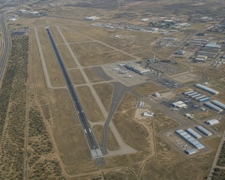 Aerial view of a West Texas regional airport with runway, terminal and hangar rows