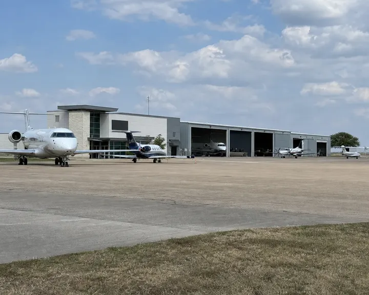 Corporate jets parked outside FBO hangars