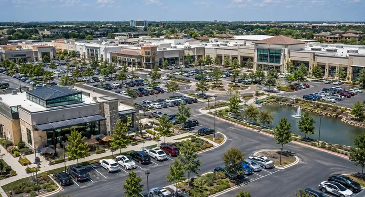 Aerial view of a shopping center parking lot on a sunny day