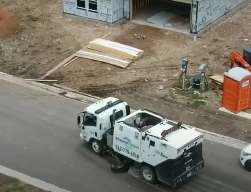 Moore Clean street sweeper working a new-build job site