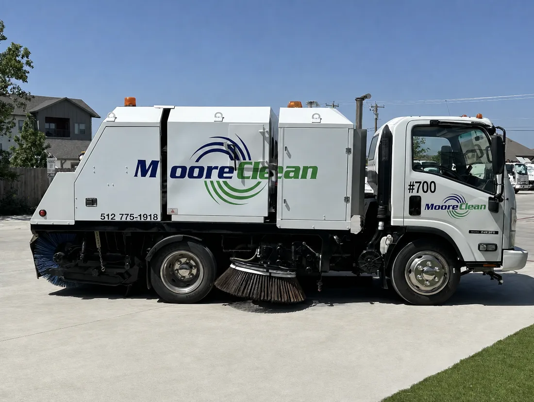 Moore Clean mechanical broom sweeper truck 700 on freshly swept pavement